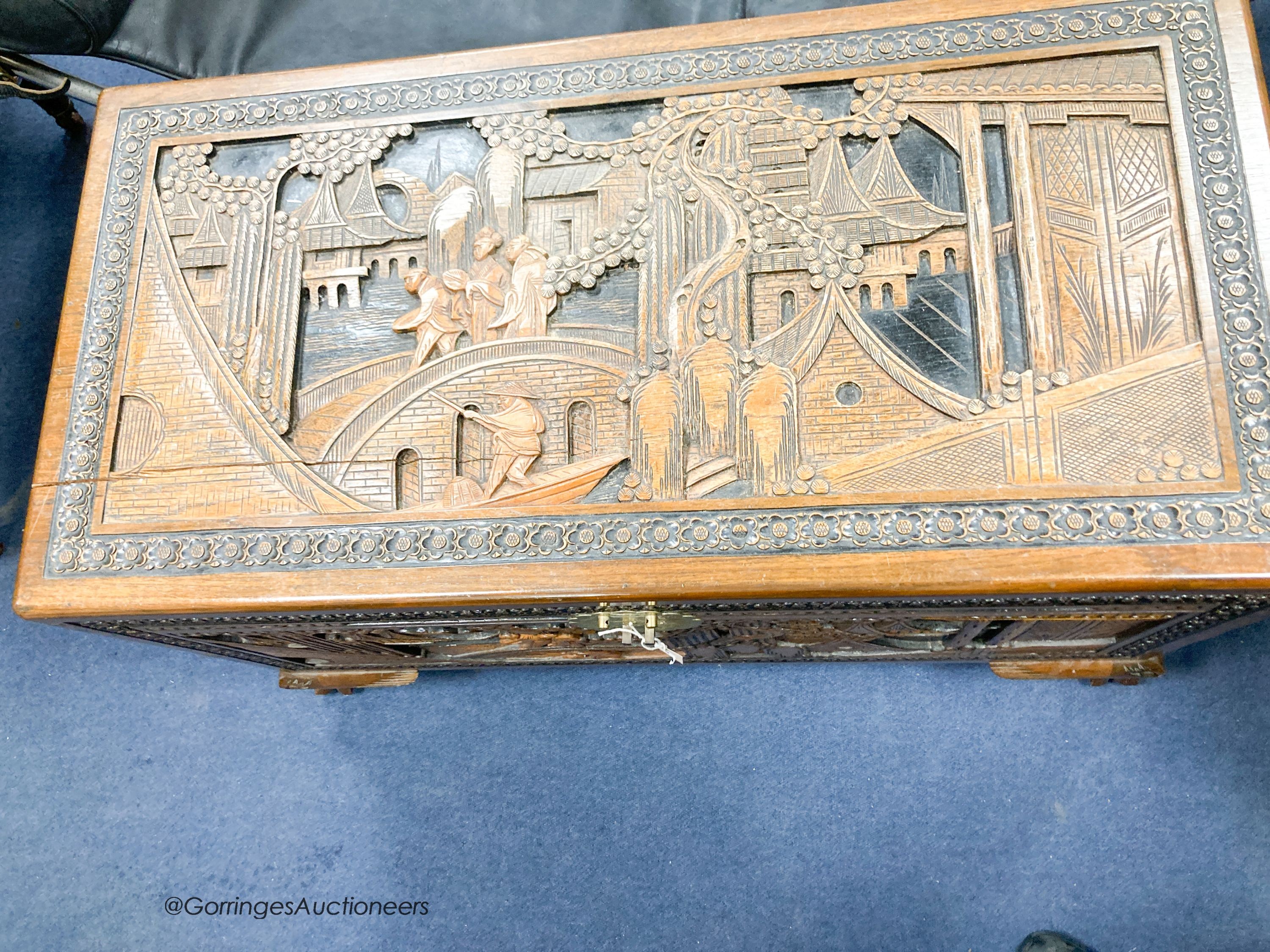 A Chinese carved camphorwood chest, width 102cm, depth 52cm, height 62cm